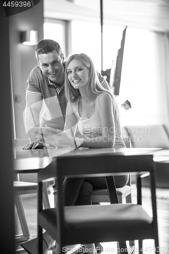 Image of couple using tablet at home