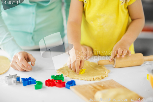 Image of mother and daughter making cookies at home