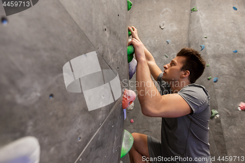 Image of young man exercising at indoor climbing gym