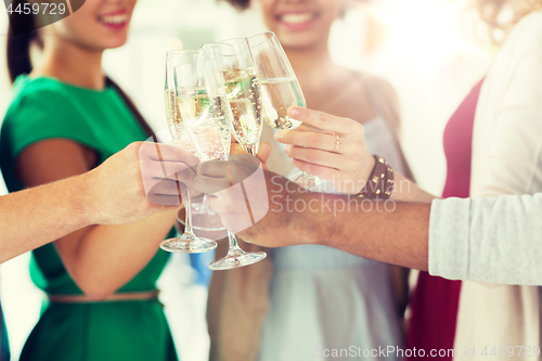 Image of friends clinking glasses of champagne at party