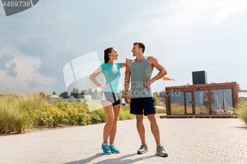 Image of happy couple in sports clothes outdoors