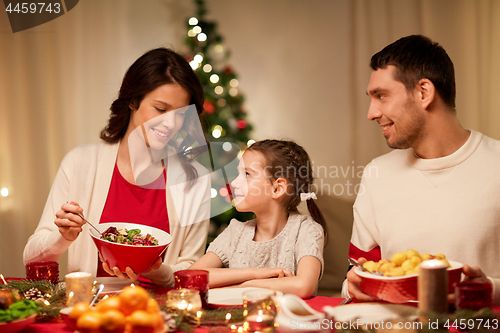 Image of happy family having christmas dinner at home