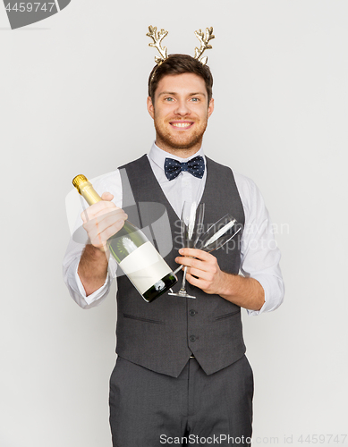 Image of man with bottle of champagne at christmas party