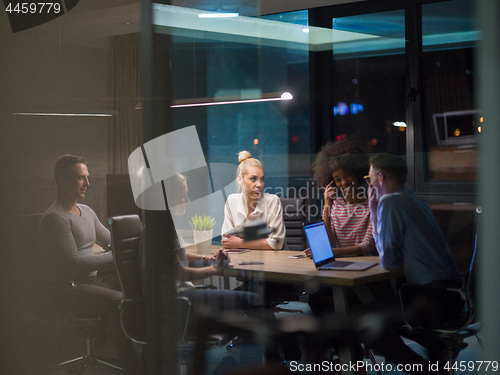 Image of Multiethnic startup business team in night office