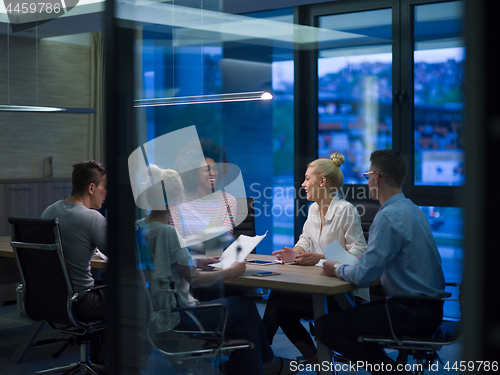 Image of Multiethnic startup business team in night office