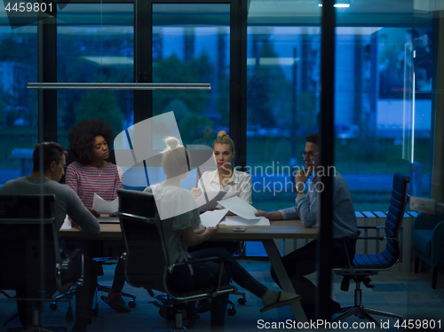 Image of Multiethnic startup business team in night office