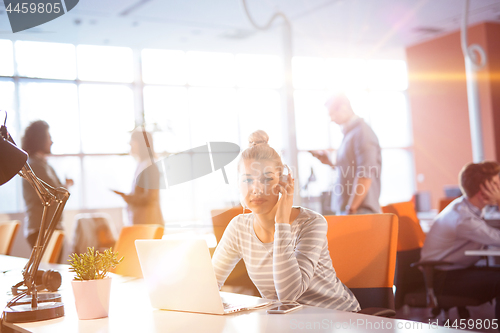 Image of Young businesswoman using computer at work