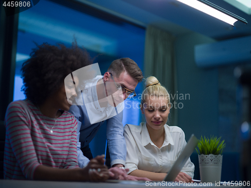 Image of Multiethnic startup business team in night office