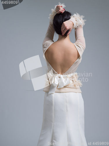 Image of Rear view of a beautiful young woman in a wedding dress