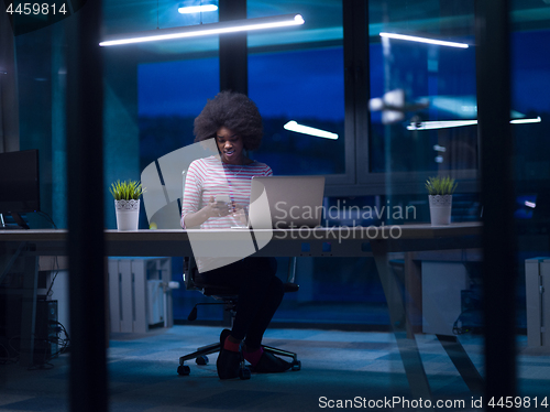 Image of black businesswoman using a laptop in startup office