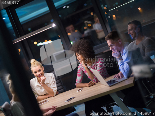 Image of Multiethnic startup business team in night office