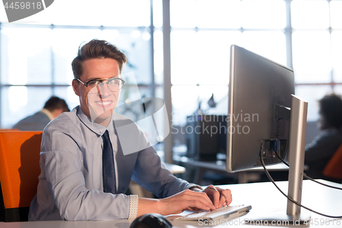 Image of businessman working using a computer in startup office