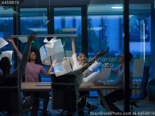 Image of multiethnic Group of young business people throwing documents