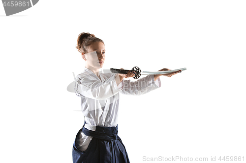 Image of Aikido master practices defense posture. Healthy lifestyle and sports concept. Woman in white kimono on white background.