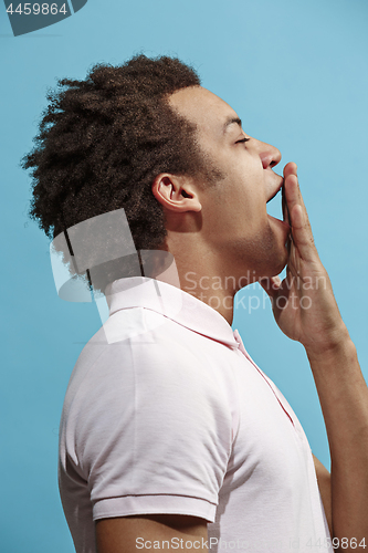 Image of Beautiful bored afro man isolated on blue background