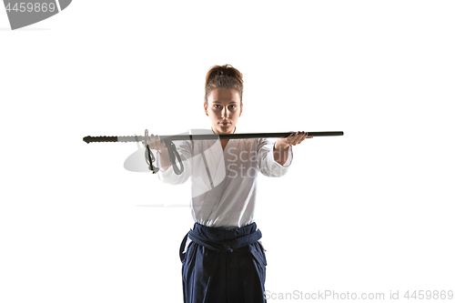 Image of Aikido master practices defense posture. Healthy lifestyle and sports concept. Woman in white kimono on white background.