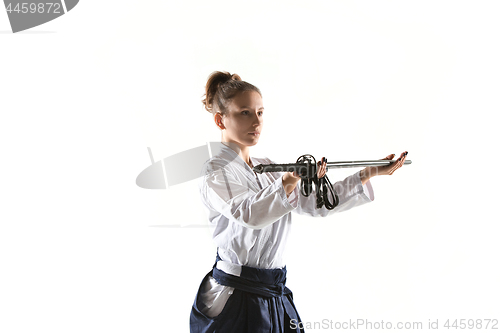 Image of Aikido master practices defense posture. Healthy lifestyle and sports concept. Woman in white kimono on white background.