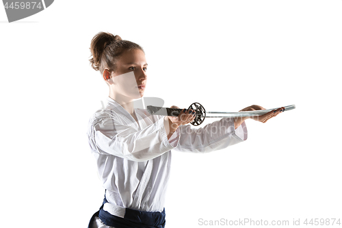 Image of Aikido master practices defense posture. Healthy lifestyle and sports concept. Woman in white kimono on white background.