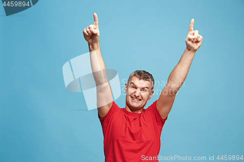 Image of Winning success man happy ecstatic celebrating being a winner. Dynamic energetic image of male model