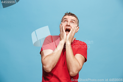 Image of Handsome man in stress isolated on blue