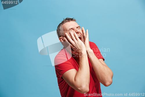 Image of Handsome man in stress isolated on blue