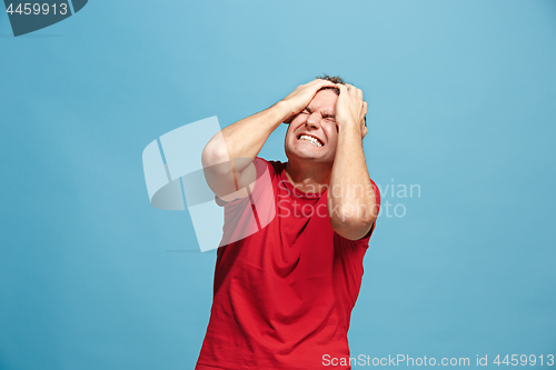 Image of Handsome man in stress isolated on blue