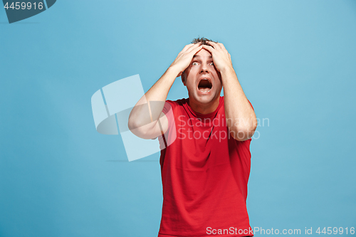 Image of Handsome man in stress isolated on blue