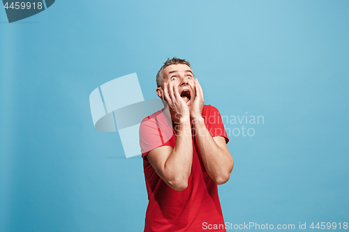 Image of Handsome man in stress isolated on blue