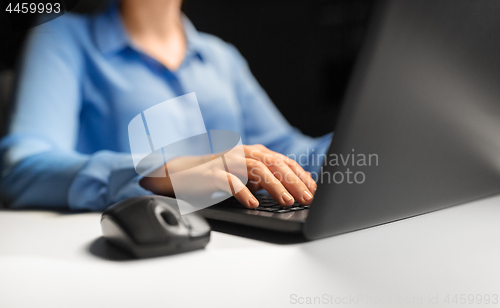 Image of close up of female hands with laptop and mouse