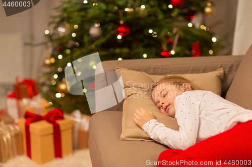 Image of girl sleeping on sofa at christmas