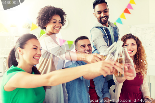 Image of happy team with drinks celebrating at office party