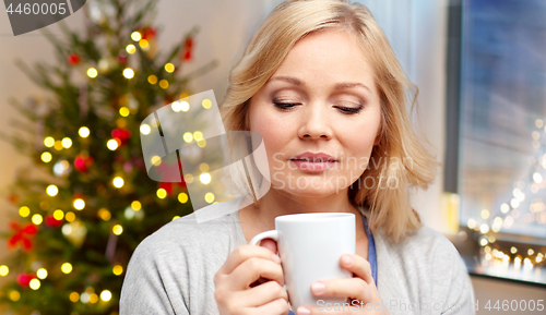 Image of woman with cup of tea or coffee on christmas