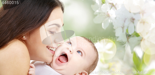 Image of mother with baby over cherry blossom background