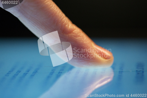 Image of close up of hand using computer touch screen