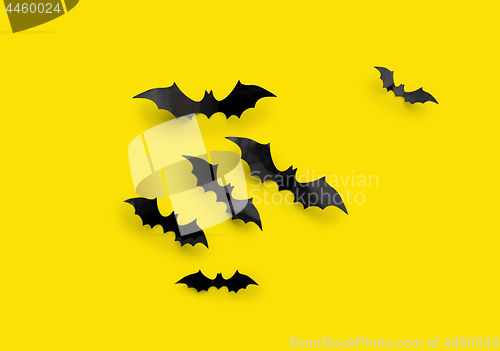 Image of black halloween bats on yellow background