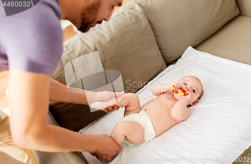 Image of close up of father and baby with rattle