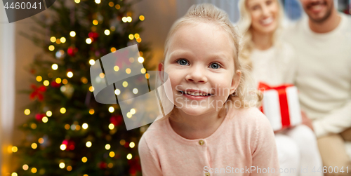 Image of happy girl with her family over christmas tree