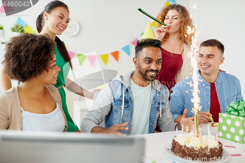 Image of office team greeting colleague at birthday party