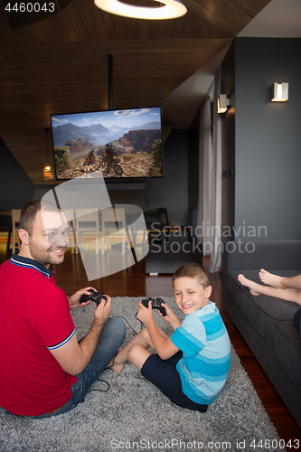 Image of Happy family playing a motocross video game