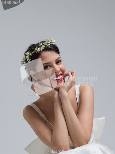 Image of young bride sitting in a wedding dress