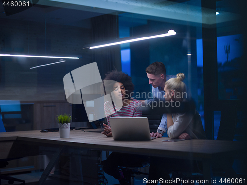Image of Multiethnic startup business team in night office