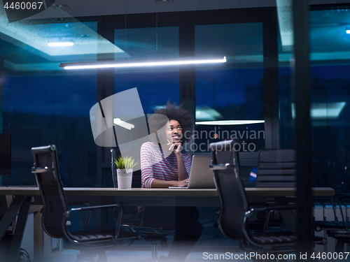 Image of black businesswoman using a laptop in startup office