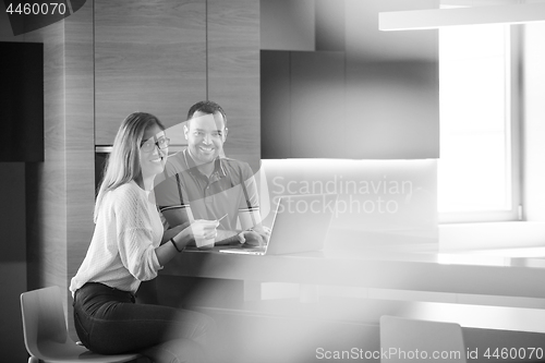 Image of happy young couple buying online