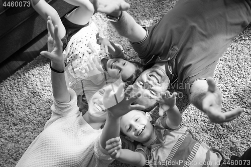 Image of happy family lying on the floor