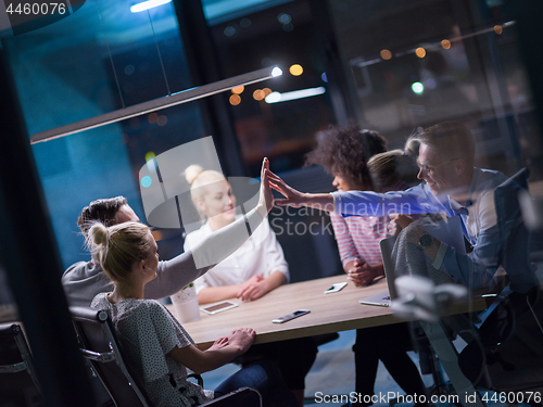 Image of Multiethnic startup business team in night office