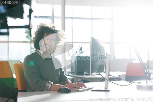 Image of businessman working using a computer in startup office