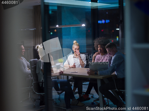 Image of Multiethnic startup business team in night office