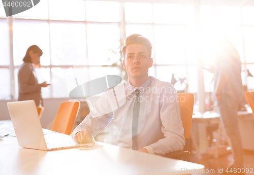 Image of Young businessman using computer at work