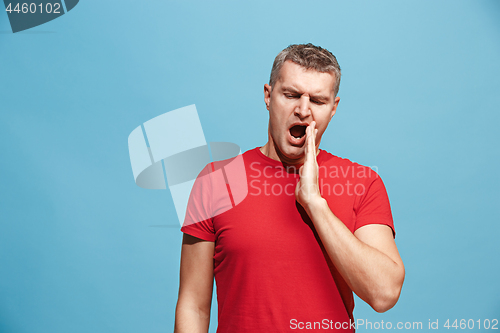 Image of Beautiful bored man bored isolated on blue background