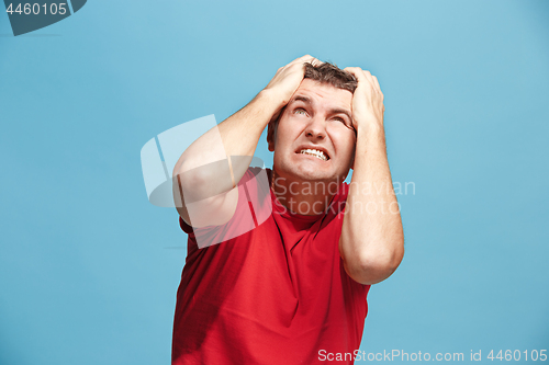 Image of Handsome man in stress isolated on blue